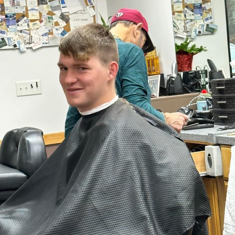 Young man smiling as he gets a haircut