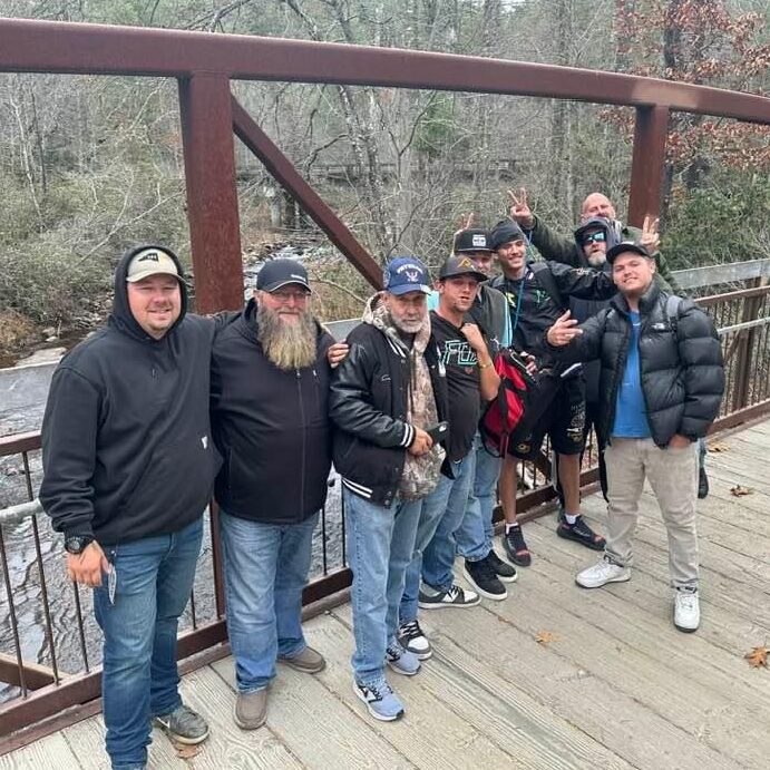 Group of men standing on a bridge